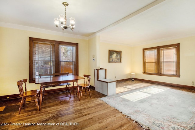 dining space featuring an inviting chandelier and hardwood / wood-style floors