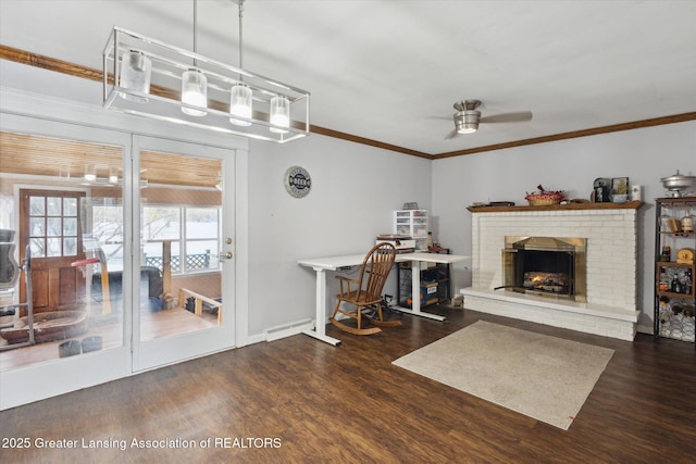 unfurnished living room featuring crown molding, ceiling fan, dark hardwood / wood-style floors, and a brick fireplace