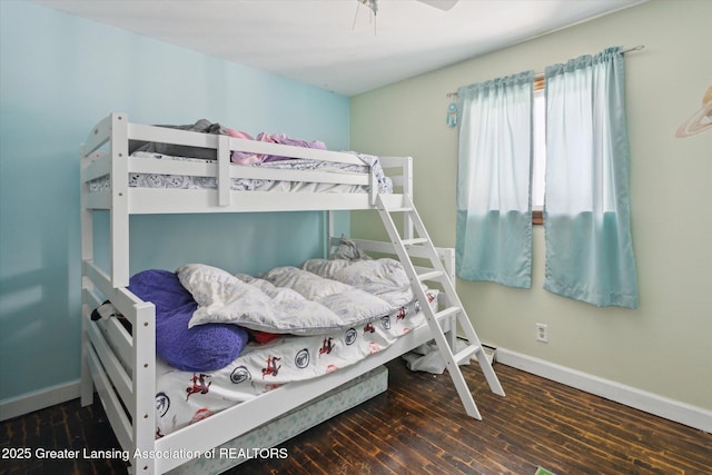 bedroom with dark hardwood / wood-style floors