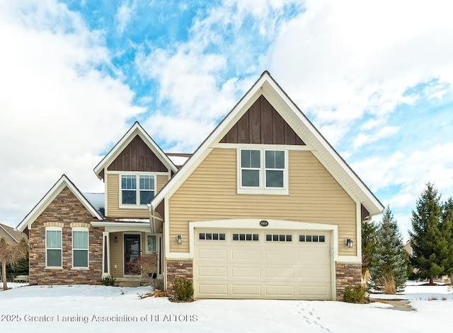 craftsman house with an attached garage, stone siding, and board and batten siding