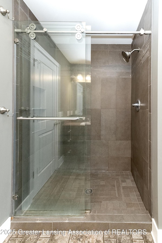 bathroom featuring a shower with shower door