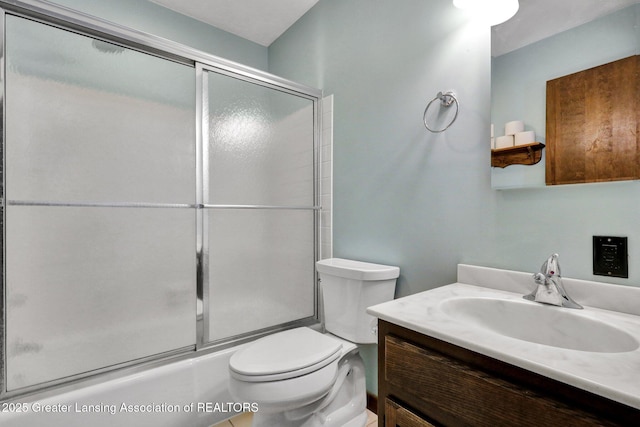 full bathroom with vanity, toilet, and combined bath / shower with glass door