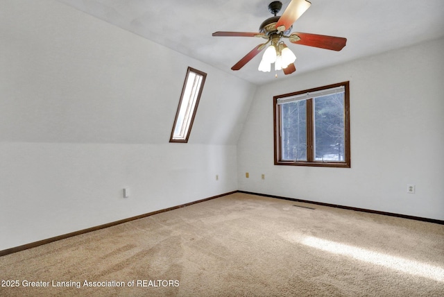 carpeted empty room featuring vaulted ceiling and ceiling fan