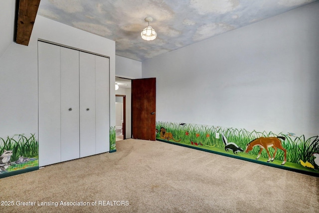 unfurnished bedroom featuring carpet floors and a closet