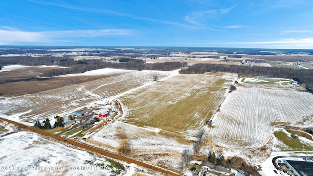 snowy aerial view featuring a rural view