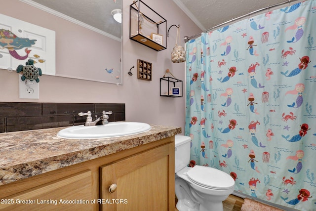 bathroom with ornamental molding, vanity, toilet, a textured ceiling, and a shower with curtain