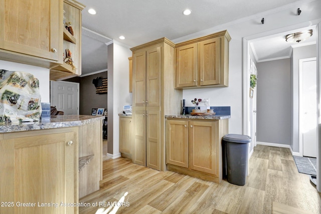 kitchen featuring light brown cabinetry, ornamental molding, and light wood-type flooring