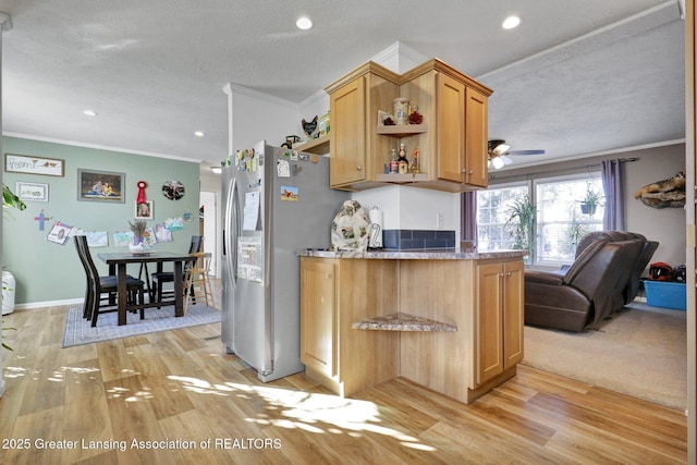 kitchen featuring light hardwood / wood-style flooring, stainless steel refrigerator with ice dispenser, ornamental molding, a textured ceiling, and light brown cabinetry