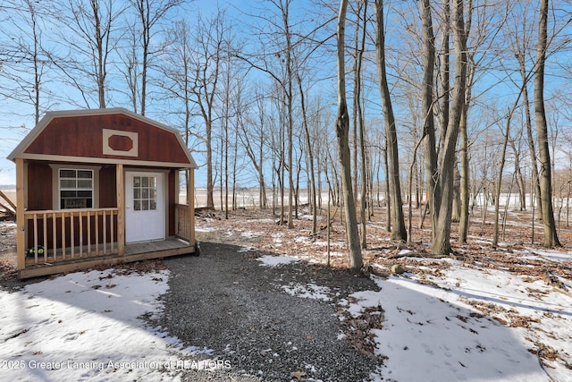 yard layered in snow with an outdoor structure