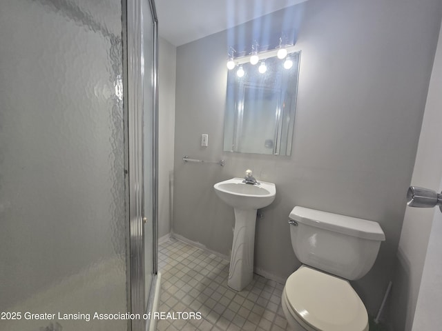 bathroom featuring an enclosed shower and toilet