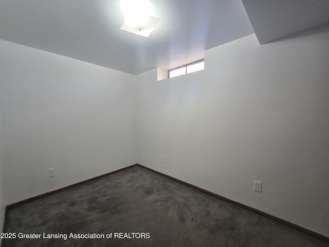 basement featuring dark colored carpet