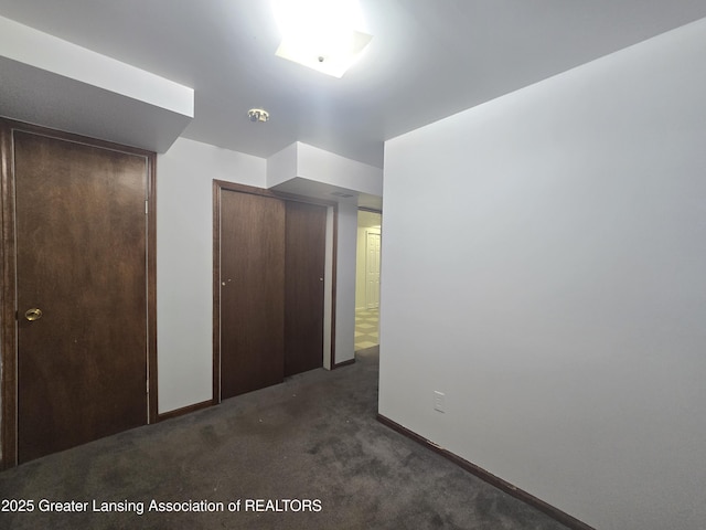 interior space with a closet and dark colored carpet