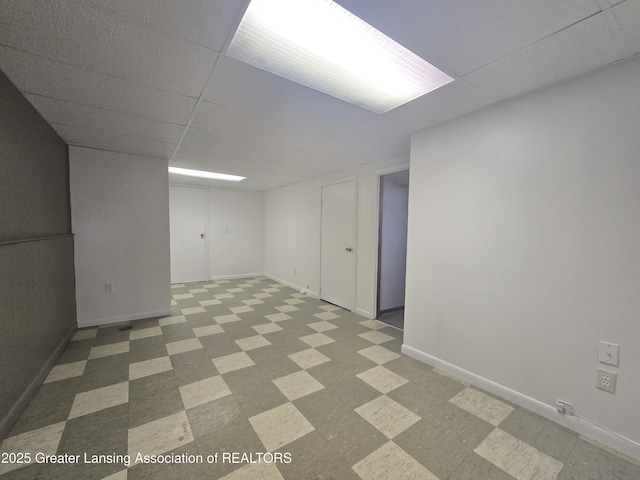 basement with a paneled ceiling