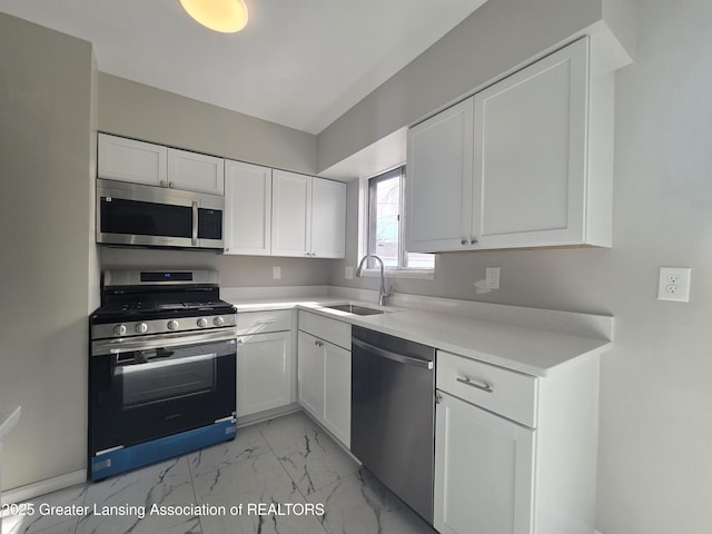 kitchen featuring sink, white cabinets, and appliances with stainless steel finishes