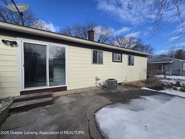 rear view of property featuring central AC and a patio area