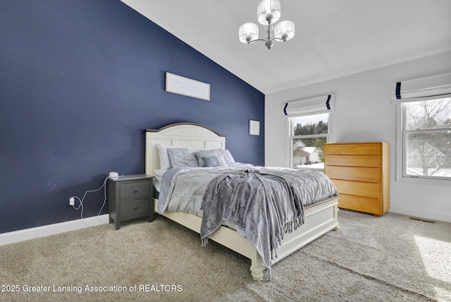 carpeted bedroom featuring lofted ceiling, multiple windows, and a notable chandelier