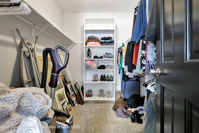 walk in closet with carpet