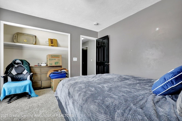 carpeted bedroom featuring a textured ceiling