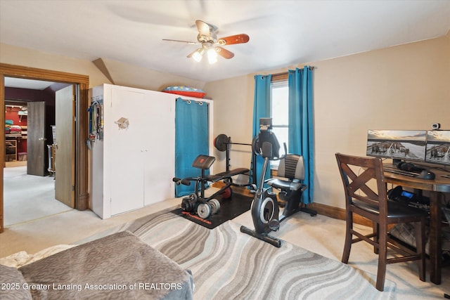 workout area with ceiling fan and light colored carpet