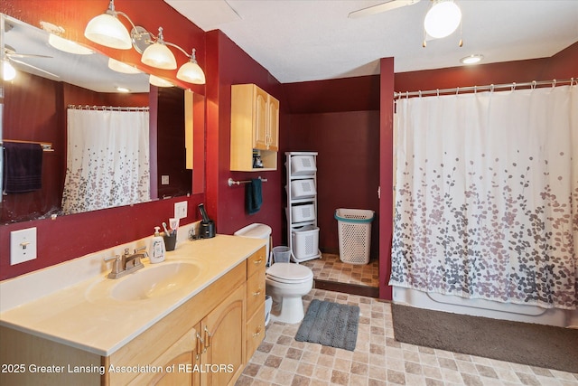 bathroom featuring vanity, a shower with curtain, toilet, and ceiling fan