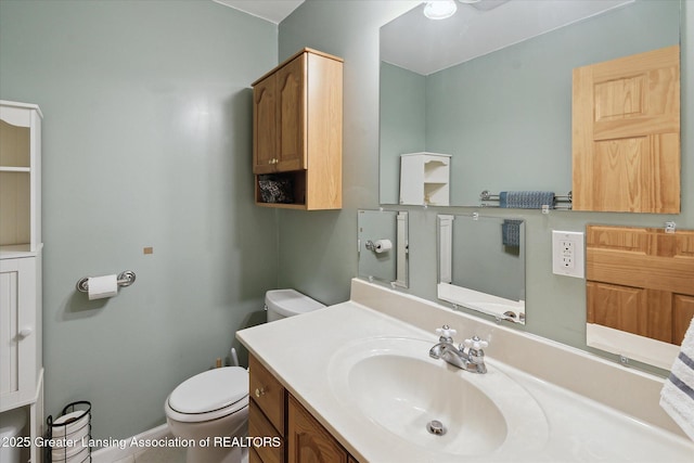 bathroom featuring vanity and toilet