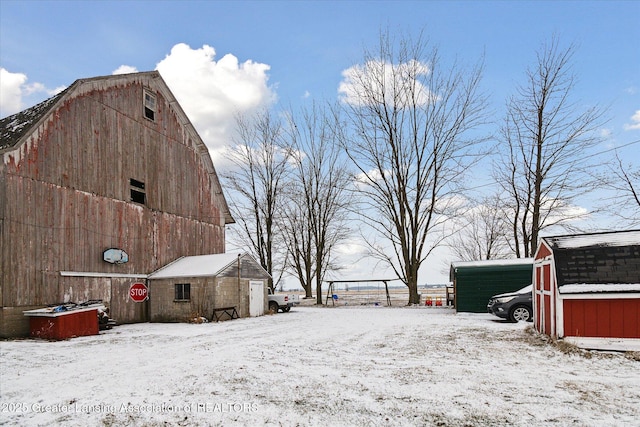 snowy yard featuring an outdoor structure