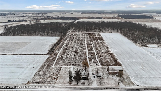 snowy aerial view featuring a rural view