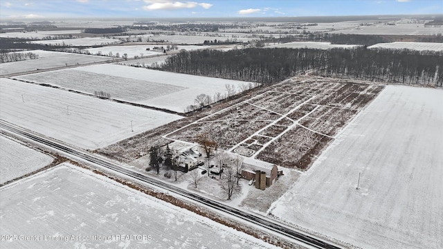 snowy aerial view featuring a rural view