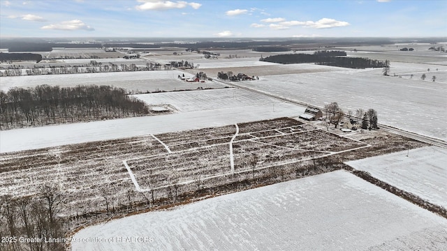 snowy aerial view featuring a rural view