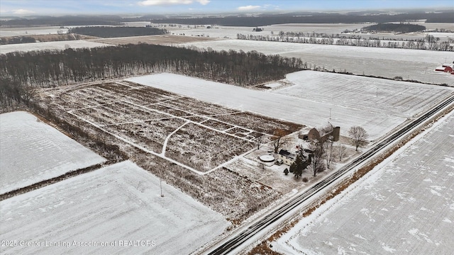 snowy aerial view featuring a rural view