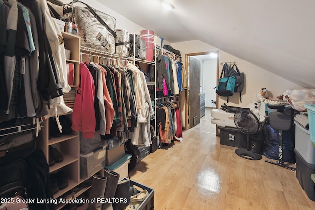 spacious closet with lofted ceiling and light hardwood / wood-style floors