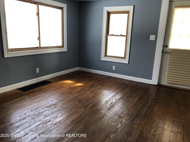 empty room with dark hardwood / wood-style floors