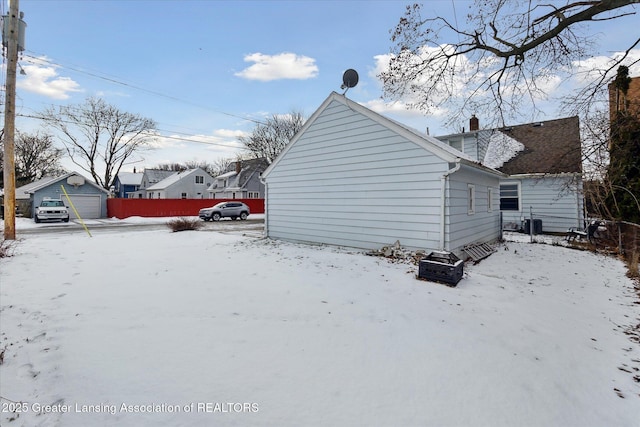 view of snow covered exterior with a garage