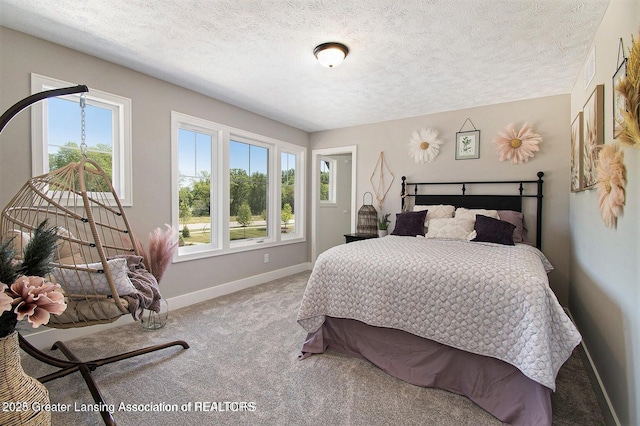 bedroom featuring multiple windows, carpet flooring, and a textured ceiling