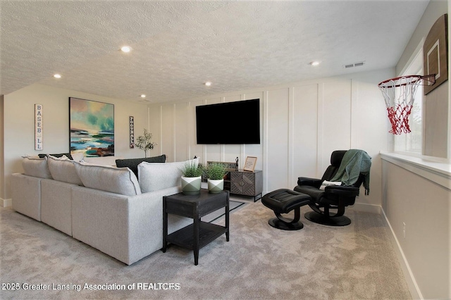 living room with light carpet and a textured ceiling