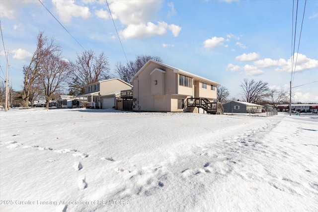 view of snow covered back of property