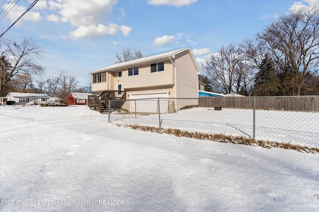 snow covered house with a garage