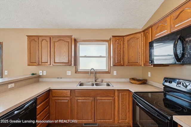 kitchen with sink, a textured ceiling, and black appliances