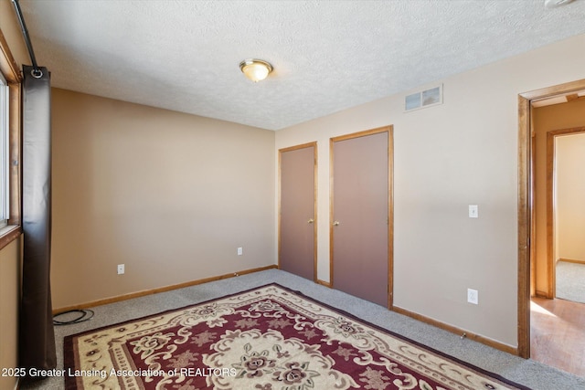 bedroom with carpet flooring and a textured ceiling