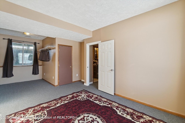 unfurnished bedroom featuring carpet floors and a textured ceiling