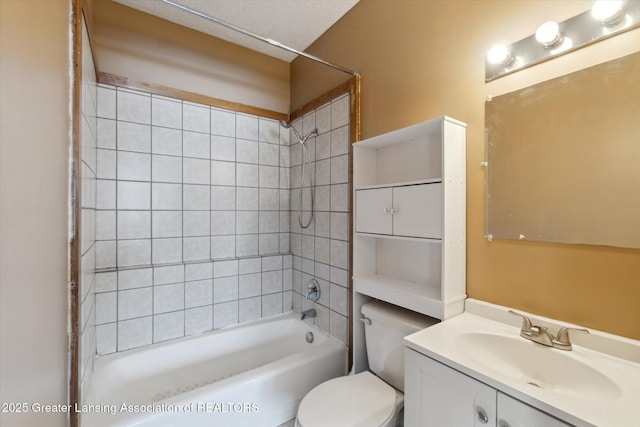 full bathroom with tiled shower / bath, vanity, and toilet