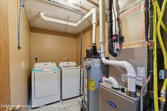 laundry area with light tile patterned flooring, independent washer and dryer, water heater, and a textured ceiling