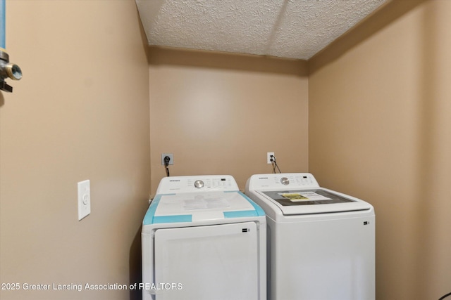 washroom with separate washer and dryer and a textured ceiling