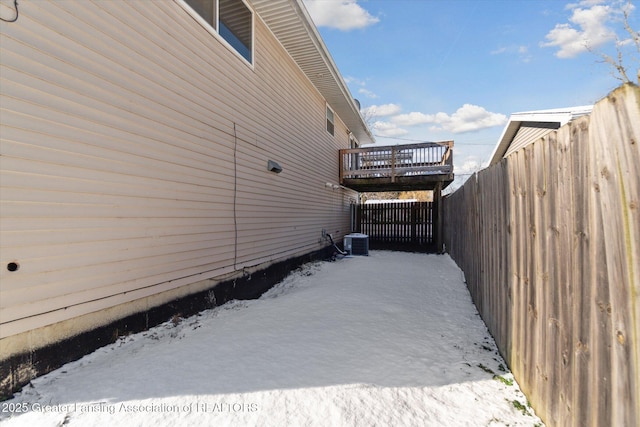 view of snowy exterior with central air condition unit