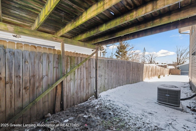 yard covered in snow featuring central AC unit