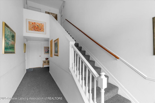 stairs featuring a high ceiling and carpet