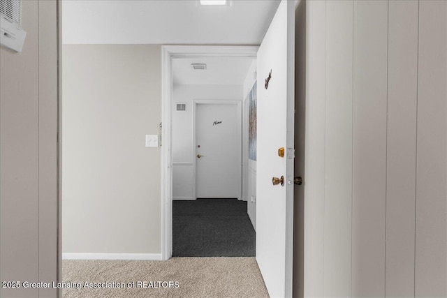 hall with light colored carpet