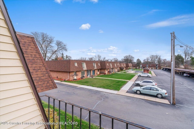 view of vehicle parking featuring a lawn