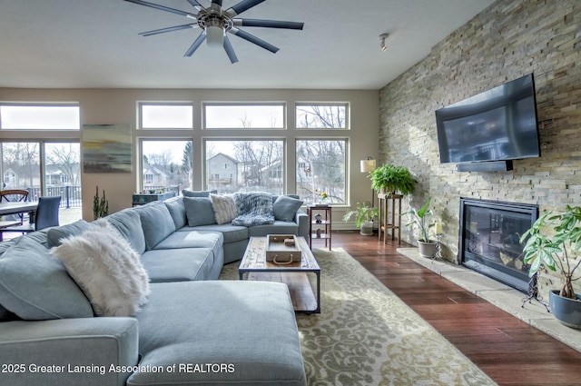 living room with ceiling fan, a fireplace, and hardwood / wood-style floors