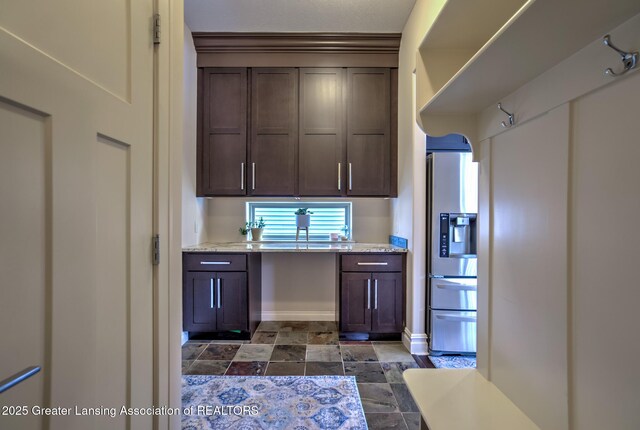 kitchen with stainless steel fridge with ice dispenser and dark brown cabinets